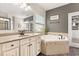 Elegant bathroom with a soaking tub, double vanity, and access to a walk-in closet at 19313 Pummelo Dr, Orlando, FL 32827