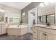 Elegant bathroom with a soaking tub, double vanity, and access to a walk-in closet at 19313 Pummelo Dr, Orlando, FL 32827