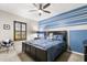 Bedroom with a blue accent wall, ceiling fan, and a comfy reading chair at 19313 Pummelo Dr, Orlando, FL 32827