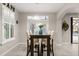 Bright dining area with a modern light fixture and a view of the outdoor pool at 19313 Pummelo Dr, Orlando, FL 32827