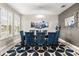 Elegant dining room with large windows, a stylish chandelier, and sophisticated blue velvet chairs at 19313 Pummelo Dr, Orlando, FL 32827