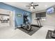 Home gym with an elliptical machine, treadmill, and a mounted TV at 19313 Pummelo Dr, Orlando, FL 32827