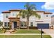 Elegant two-story home featuring lush landscaping, a tile roof, and a stone-accented facade at 19313 Pummelo Dr, Orlando, FL 32827