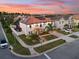 An exterior aerial view of the two-story home shows professional landscaping, a paver driveway, and solar panels at 19313 Pummelo Dr, Orlando, FL 32827