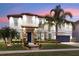 Elegant two-story home boasts lush landscaping and a tiled roof, creating curb appeal at 19313 Pummelo Dr, Orlando, FL 32827