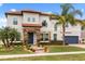 Elegant two-story home with lush landscaping, a tile roof, and a stone-accented facade at 19313 Pummelo Dr, Orlando, FL 32827