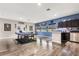 Spacious game room featuring a ping pong table, kitchenette, and laminate flooring at 19313 Pummelo Dr, Orlando, FL 32827