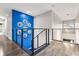 Second-floor hallway with modern railings and a blue accent wall at 19313 Pummelo Dr, Orlando, FL 32827