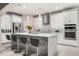 Bright, modern kitchen featuring a large island with seating, stainless steel appliances, and white cabinetry at 19313 Pummelo Dr, Orlando, FL 32827