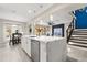Open-concept kitchen featuring a large island with a marble countertop and stainless steel appliances at 19313 Pummelo Dr, Orlando, FL 32827