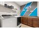 Well-organized laundry room with modern appliances and ample storage cabinets at 19313 Pummelo Dr, Orlando, FL 32827
