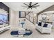 Open-concept living room featuring a modern staircase, custom shelving, and views of the kitchen at 19313 Pummelo Dr, Orlando, FL 32827