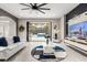 Contemporary living room with tile floors, a modern fan, a TV, and folding glass doors to the pool area at 19313 Pummelo Dr, Orlando, FL 32827