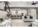 View of a modern living room showcasing the staircase with adjacent, open views of the kitchen at 19313 Pummelo Dr, Orlando, FL 32827