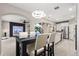 Open-concept living space with a dining table adjacent to a modern kitchen, with easy access to other rooms at 19313 Pummelo Dr, Orlando, FL 32827