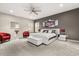 Expansive main bedroom suite with a king bed, seating area, and abundant natural light at 19313 Pummelo Dr, Orlando, FL 32827
