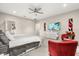 Spacious bedroom with neutral tones, features a ceiling fan, TV, and decorative art at 19313 Pummelo Dr, Orlando, FL 32827