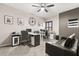 Home office with multiple workstations, comfortable seating, and natural light from the shuttered windows at 19313 Pummelo Dr, Orlando, FL 32827