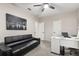 Office with neutral walls, black leather sofa, white desk, and a city artwork at 19313 Pummelo Dr, Orlando, FL 32827