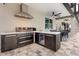 A well-equipped outdoor kitchen features a stainless grill, beverage fridge, sink, and counter space at 19313 Pummelo Dr, Orlando, FL 32827