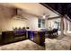 A fully-equipped outdoor kitchen and dining area is featured on the home's rear patio at 19313 Pummelo Dr, Orlando, FL 32827