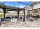 The screened-in patio features a fireplace, an outdoor kitchen, and lounge chairs near the pool at 19313 Pummelo Dr, Orlando, FL 32827