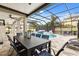 An outdoor dining space overlooks the in-ground pool with waterfall features, privacy screens, and lounge seating at 19313 Pummelo Dr, Orlando, FL 32827