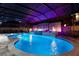 A custom in-ground pool is surrounded by a screened enclosure and features a waterfall and an in-ground spa at 19313 Pummelo Dr, Orlando, FL 32827