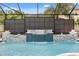An inviting in-ground pool with tiled waterfall features and privacy screens with integrated fire bowls at 19313 Pummelo Dr, Orlando, FL 32827
