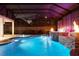 A backyard pool with a screened enclosure, a waterfall feature and an in-ground spa with accent lighting at 19313 Pummelo Dr, Orlando, FL 32827