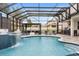 A beautiful screened-in pool with waterfall features, poolside seating, and an outdoor living area at 19313 Pummelo Dr, Orlando, FL 32827
