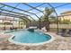 A beautiful screened-in pool featuring water features, a spa, and an outdoor patio with lounge chairs at 19313 Pummelo Dr, Orlando, FL 32827