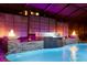 Beautiful outdoor pool and spa area with a modern water feature, fire bowls, and ambient lighting at 19313 Pummelo Dr, Orlando, FL 32827