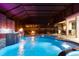 Luxurious outdoor pool and spa area with a covered lanai, outdoor kitchen, and inviting lounge seating at 19313 Pummelo Dr, Orlando, FL 32827