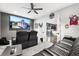 Home theater featuring plush seating, large screen, and adjacent game room at 19313 Pummelo Dr, Orlando, FL 32827