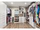 Spacious walk-in closet with custom shelving, drawers, and ample storage for clothing and accessories at 19313 Pummelo Dr, Orlando, FL 32827