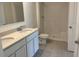 Modern bathroom with double vanity, quartz countertop, and a tiled shower with a built-in seat at 2005 Canton Park Dr, Winter Haven, FL 33881