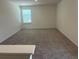 Spacious, carpeted bedroom with a large window offering ample natural light at 2005 Canton Park Dr, Winter Haven, FL 33881