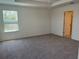Bright, carpeted bedroom with a window and ample space, ready for personalization at 2005 Canton Park Dr, Winter Haven, FL 33881