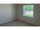 Bright bedroom featuring neutral walls, tiled floor and a window allowing natural light at 2005 Canton Park Dr, Winter Haven, FL 33881