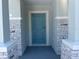 Stylish blue front door framed by stone pillars, offering a welcoming entrance at 2005 Canton Park Dr, Winter Haven, FL 33881