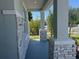 Covered front porch highlighting stone-clad columns and a peaceful outdoor space at 2005 Canton Park Dr, Winter Haven, FL 33881