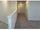 Upstairs hallway with neutral colors and views of the doors and doorways to bedrooms at 2005 Canton Park Dr, Winter Haven, FL 33881