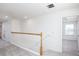 Upstairs hallway with carpet, white railing, and view into an adjacent room at 2005 Canton Park Dr, Winter Haven, FL 33881