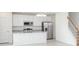 Modern kitchen with stainless steel appliances, granite countertops, island sink, and staircase access at 2005 Canton Park Dr, Winter Haven, FL 33881