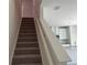 Carpeted staircase leading to the upper level with views of the modern kitchen at 2005 Canton Park Dr, Winter Haven, FL 33881