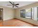 A bedroom is well-lit by a large window and enhanced by wood floors at 2539 Antilles Dr, Winter Park, FL 32792