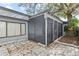 Home exterior view with screened patio, showing outdoor living space and mature trees at 2539 Antilles Dr, Winter Park, FL 32792