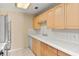 Bright kitchen featuring light wood cabinetry, white tiled backsplash, and updated appliances for convenience at 2539 Antilles Dr, Winter Park, FL 32792
