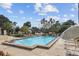 Sparkling community pool surrounded by lounge chairs and palm trees, perfect for relaxation at 2539 Antilles Dr, Winter Park, FL 32792